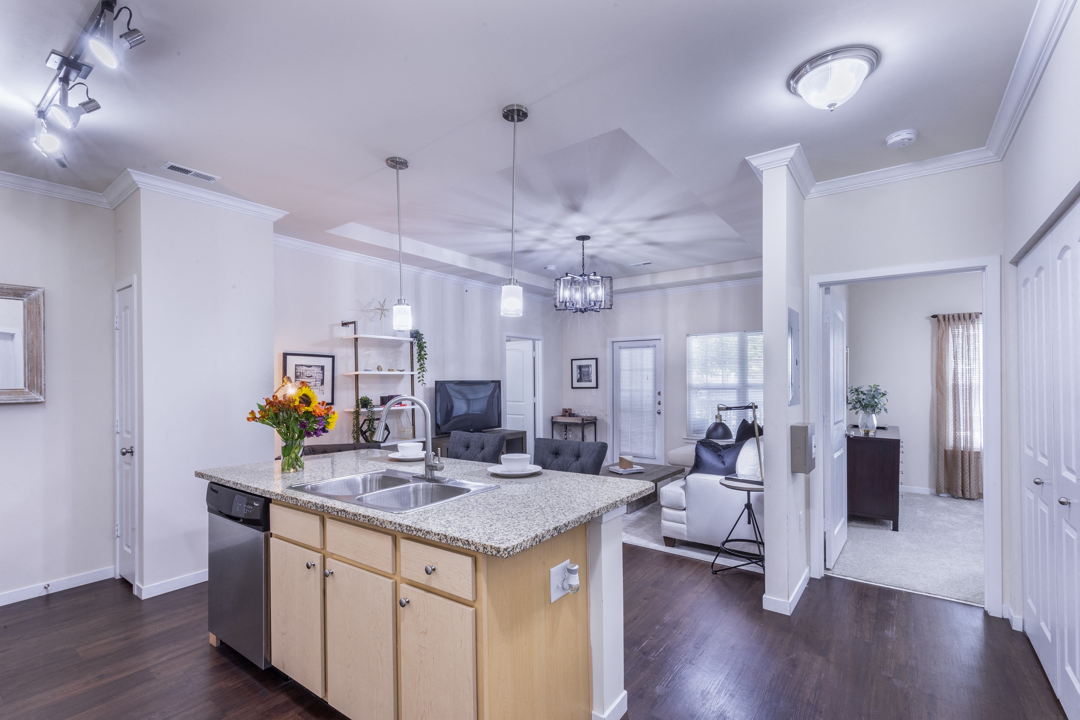 a kitchen with an island and a living room with a couch at Aventura at Forest Park, St. Louis,Missouri